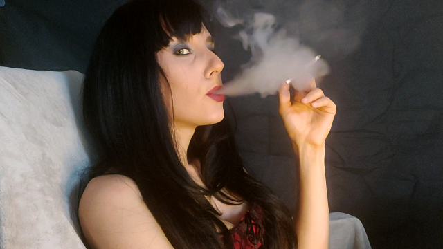 Seductive brunette smoking a cigarette